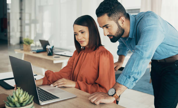istock Business people, teamwork and advice on computer for office planning, project proposal and startup advice in marketing. Professional woman, manager or employees reading on laptop for website research 1770663432