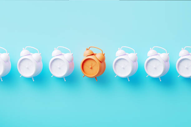 istock White And Orange Colored Alarm Clocks On Blue Background 1770681969