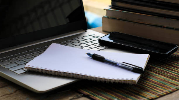 istock books, pens and laptop on the table 1770681971