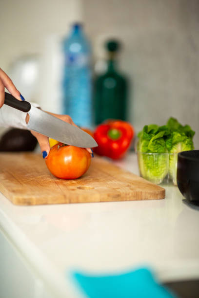istock female hand cutting vegetables with knife 1770684834