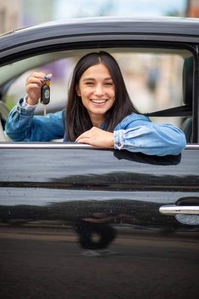 istock smiling young woman with keys in hand 1770685424