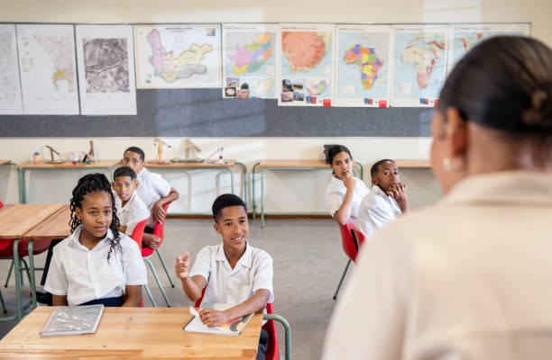 istock School boy answering teacher's question in classroom 1770688120