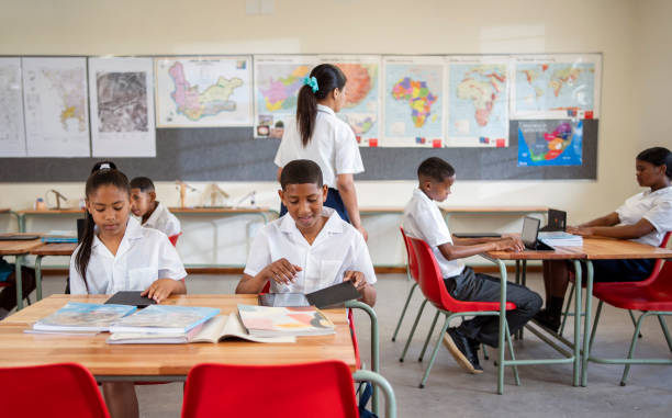 istock Students sitting at desks in classroom 1770689265
