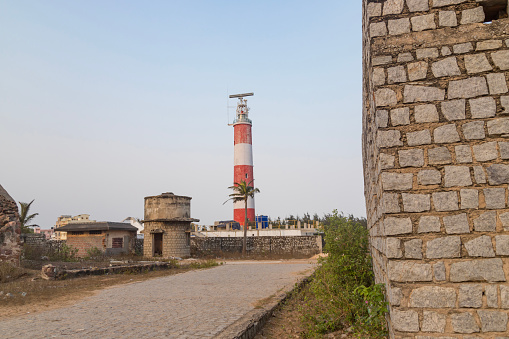 Gopalpur lighthouse with red and white stripes in cloudless blue sky gopalpur near Gopalpur Fort, odisha, India