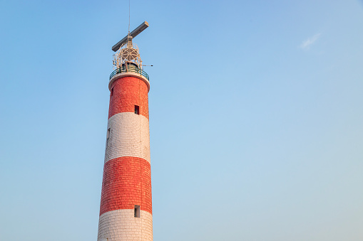 Gopalpur lighthouse with red and white stripes in cloudless blue sky gopalpur near Gopalpur Fort, odisha, India