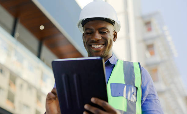istock Black man in construction, tablet and architect working on floor plan, inspection and maintenance job outdoor. Check digital blueprint for architecture project, design software and quality assurance 1770706181