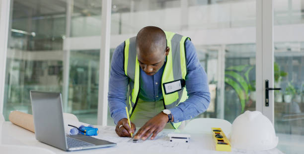 istock Architecture man, drawing and blueprint planning, construction and project development or renovation on laptop. Engineering contractor or african designer for online floor plan, lines or sketch tools 1770706198