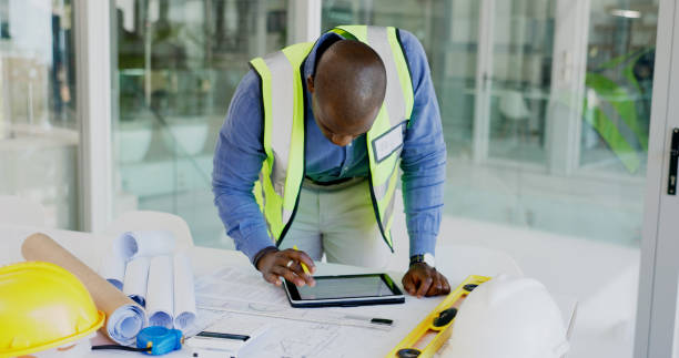 istock Black man, tablet and review floor plan, construction or architect working on maintenance job in office. Assessment, digital blueprint for architecture project and productivity with design software 1770716591