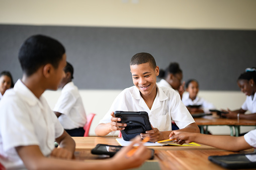 Schoolboys working together using digital tablets in STEM classroom