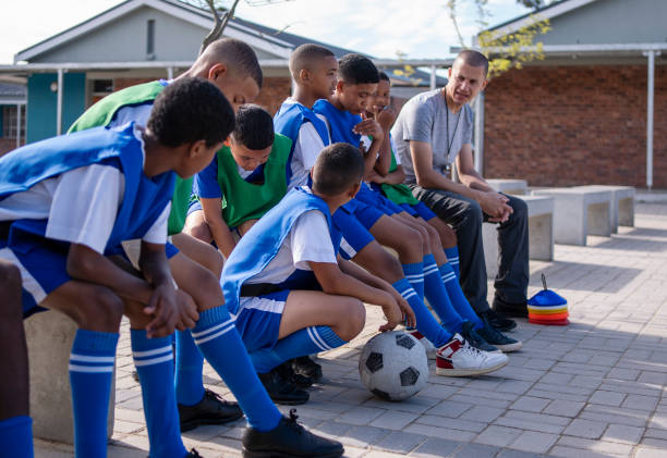 istock Coach talking about the game plan with his schoolboys soccer team 1770731248