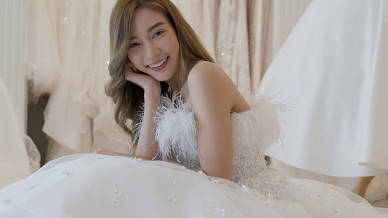 Beautiful bride, young asian woman wearing happy wedding dress and getting ready for wedding, wedding concept