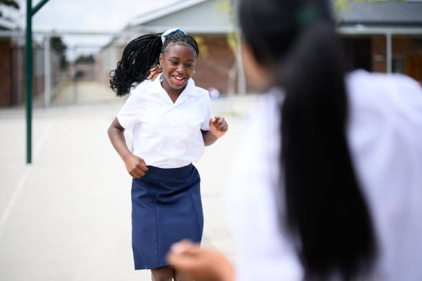istock Schoolgirl skipping with friends during break time 1770737274