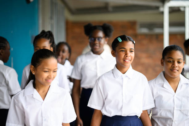 istock Schoolgirls walking in corridor together 1770739964