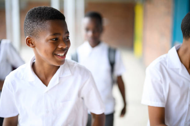 istock Happy schoolboy walking in corridor with friends 1770740393