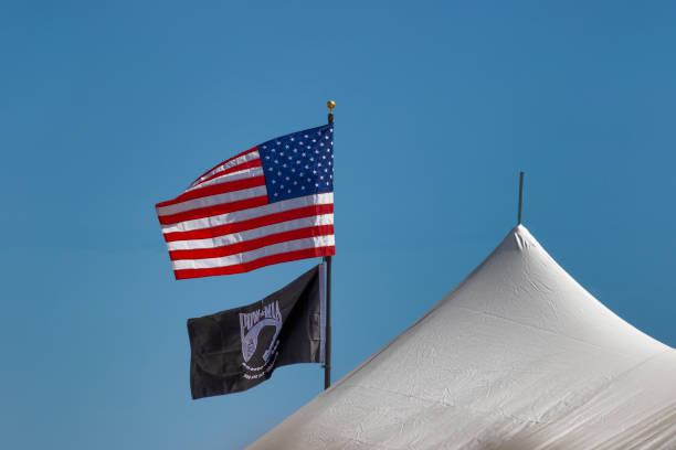 istock American and POW Flag disdplayed above a white tent 1770741062