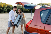 Young couple packs suitcases, ready for a love-filled trip