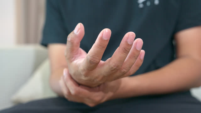 man's hand is trembling because of Parkinson's disease.