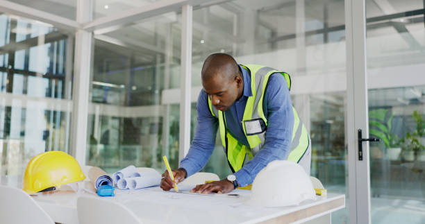 Black man, architect and drawing blueprint for construction job, engineering and design with developer. Contractor, maintenance and architecture project with floor plan, paperwork and productivity