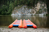 The catamaran stands on the bank of the river, inflatable rafting for rafting on mountain rivers, tourist equipment for hiking on the water, extreme on the river.