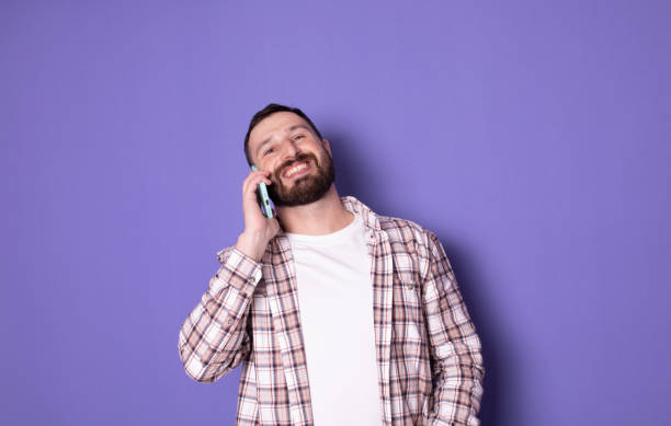 istock Bearded smiling happy caucasian man talking speaking by mobile cell phone. 1770753976