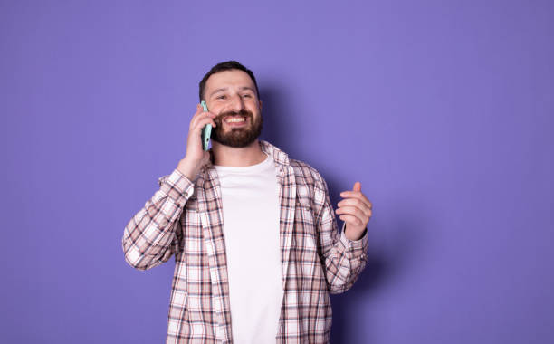 istock Bearded smiling happy caucasian man talking speaking by mobile cell phone. 1770753991
