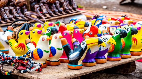 Colorful bird ceramic whistles on the street souvenir shop in Peru