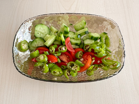 Fresh salad in a bowl on wood table