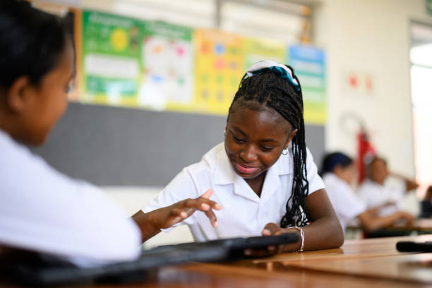 istock African schoolgirls using touch screen digital tablet in class 1770758480