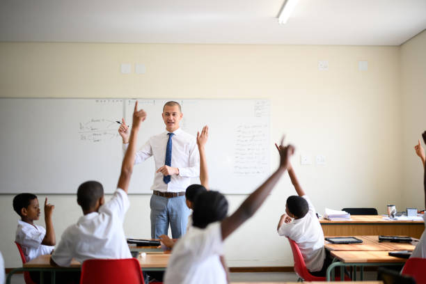 istock Passionate teacher in front of class with children hands raise to answer question background with copy space 1770759702
