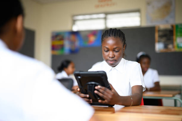 istock Over shoulder view African schoolgirl using digital tablet 1770760961
