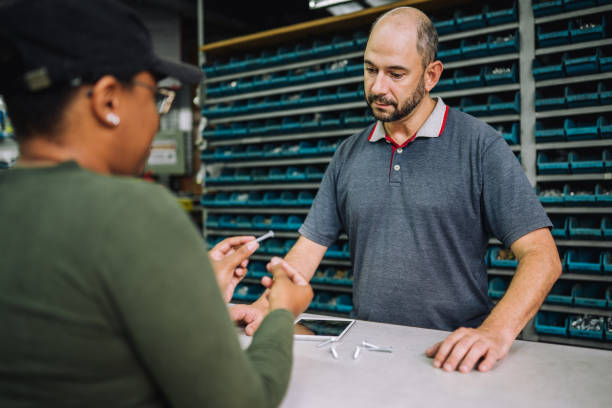 istock Customer asking the owner of a hardware store for advice on screws 1770776880