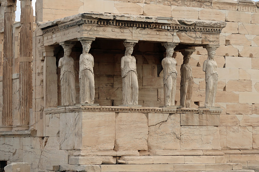 Acropolis, Athens, Greece, October 18, 2023. The temple of Athena Polias or the Erechtheion. featuring statues in the Porch of the Maidens. Autumn day outdoors