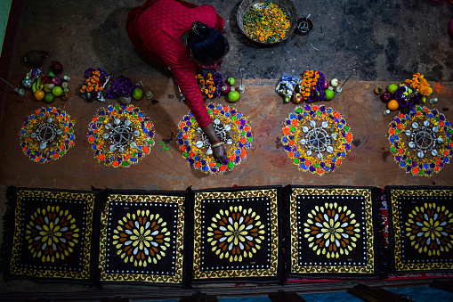 Mandala is  a pattern made using flowers, colours and seeds for celebrating bhaitika. The drawing of mandalas is tied to the myth of a sister bargaining for her brother’s life with Yama, the god of death.