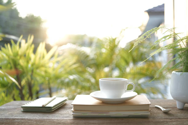 istock White coffee cup and diary notebooks and plant pot chill outdoor drinking 1770796347