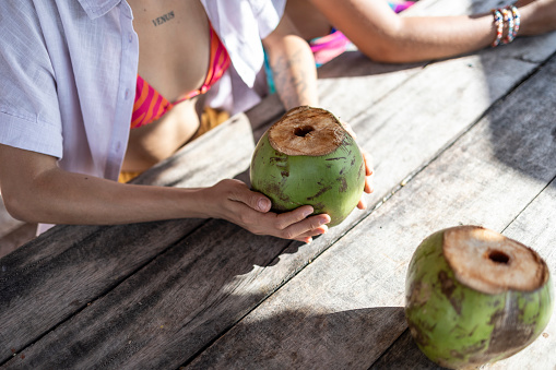 Coconuts on the table at a beach kiosk