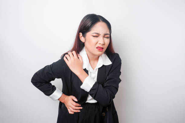 tired upset young business woman suffering from pain, muscle spasm at workplace. fatigue, deadline, pain and incorrect posture - physical injury backache occupation office imagens e fotografias de stock