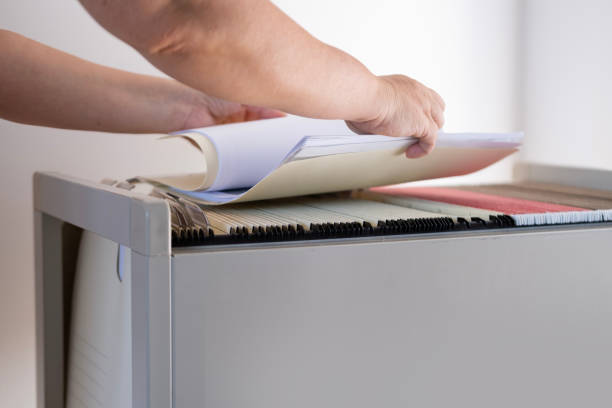 istock female hands through folders In Document Storage close-up, Home Archive, Record Keeping, Information Retrieval, File Organization, Document Indexing, Filing System 1770819192
