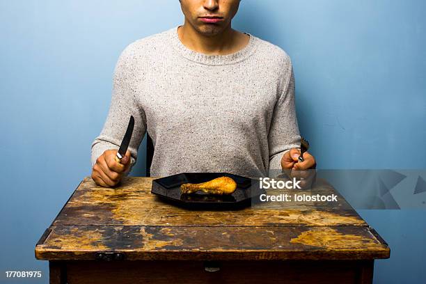 Young Man Having A Chicken Drumstick To Eat Stock Photo - Download Image Now - Adult, Adults Only, Antique