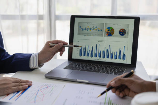 istock professional businessman Group of confident young businessmen analyze data using computer in a collaborative meeting discussing financial data analysis and business strategy project. 1770827438