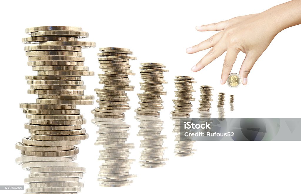 stacks of thai coins with hand, white background Adult Stock Photo