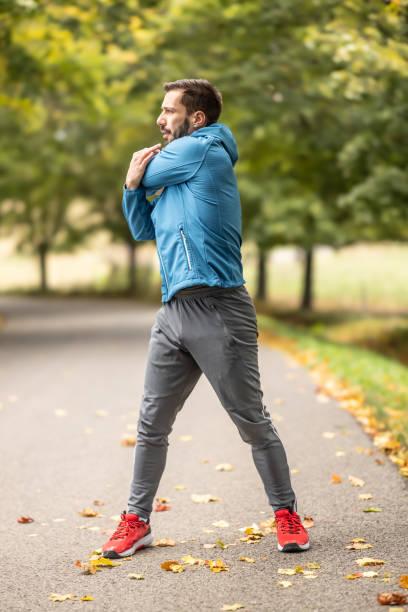 istock A young athlete is warming up before running training in the park. 1770833344