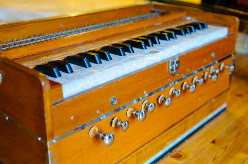 Old fashioned hand-operated squeezebox, which uses bellows behind to provide air to sound internal reeds
