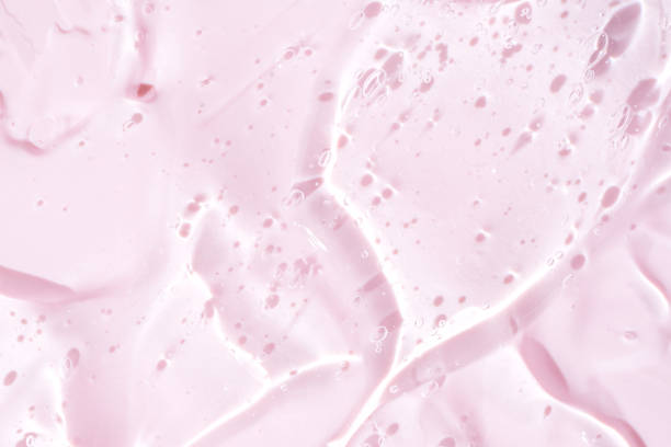 istock Hyaluronic acid gel. Textured background with oxygen bubbles, pink background. 1770843207