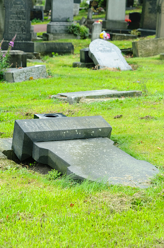 Headstones in a graveyard deliberately laid flat for safety reasons after becoming unstable