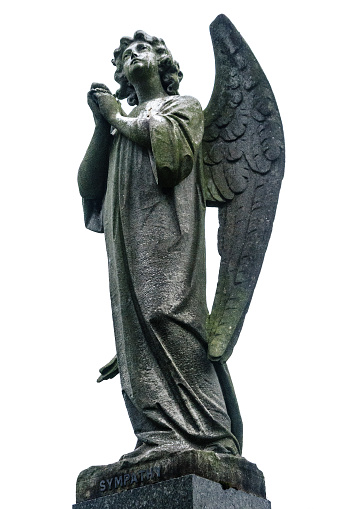 Stone angel in a graveyard with the word \