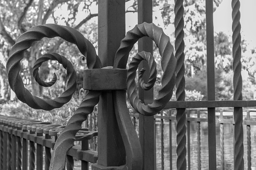 Black and white photo swirl pattern metal work gate