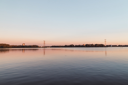 Colorful water surface and sky during sunset in summer in Almere, Netherlands.