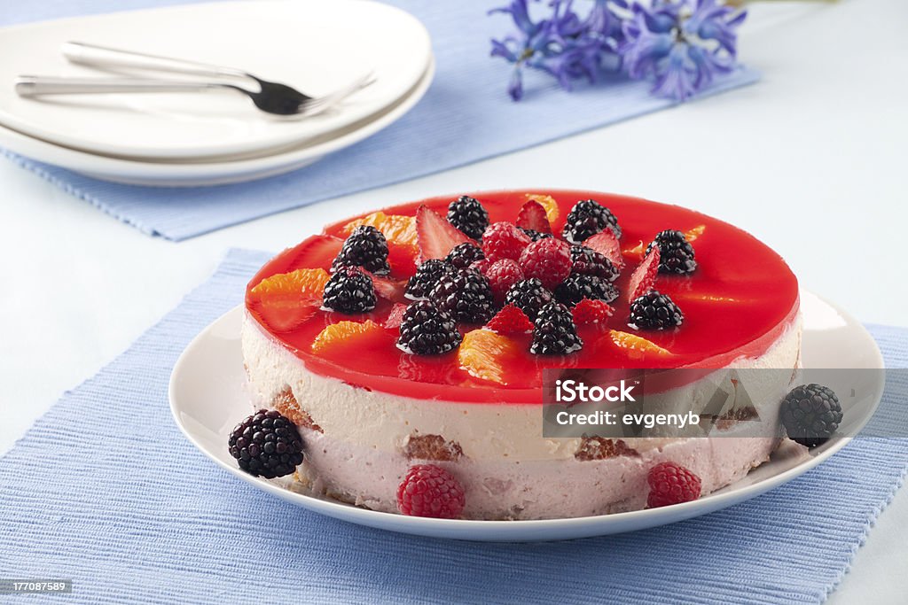 Fruit Yogurt Cake "Fruit yogurt cake. Cream and yogurt based fruit filling topped with jelly. Raspberries, blackberries, strawberries, and oranges." Baked Pastry Item Stock Photo