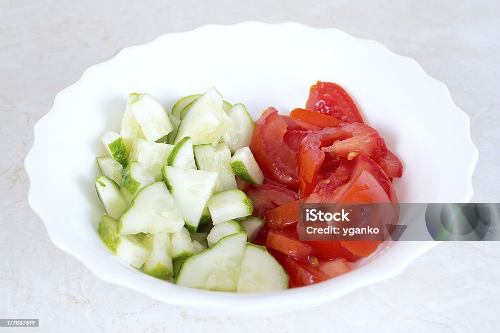 Salad of tomatoes and cucumbers in the bowl. Appetizer Stock Photo