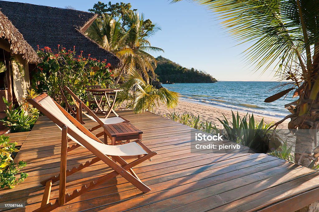 Terrace with two chairs by the ocean Terrace at sunset on a tropical beach Madagascar Stock Photo